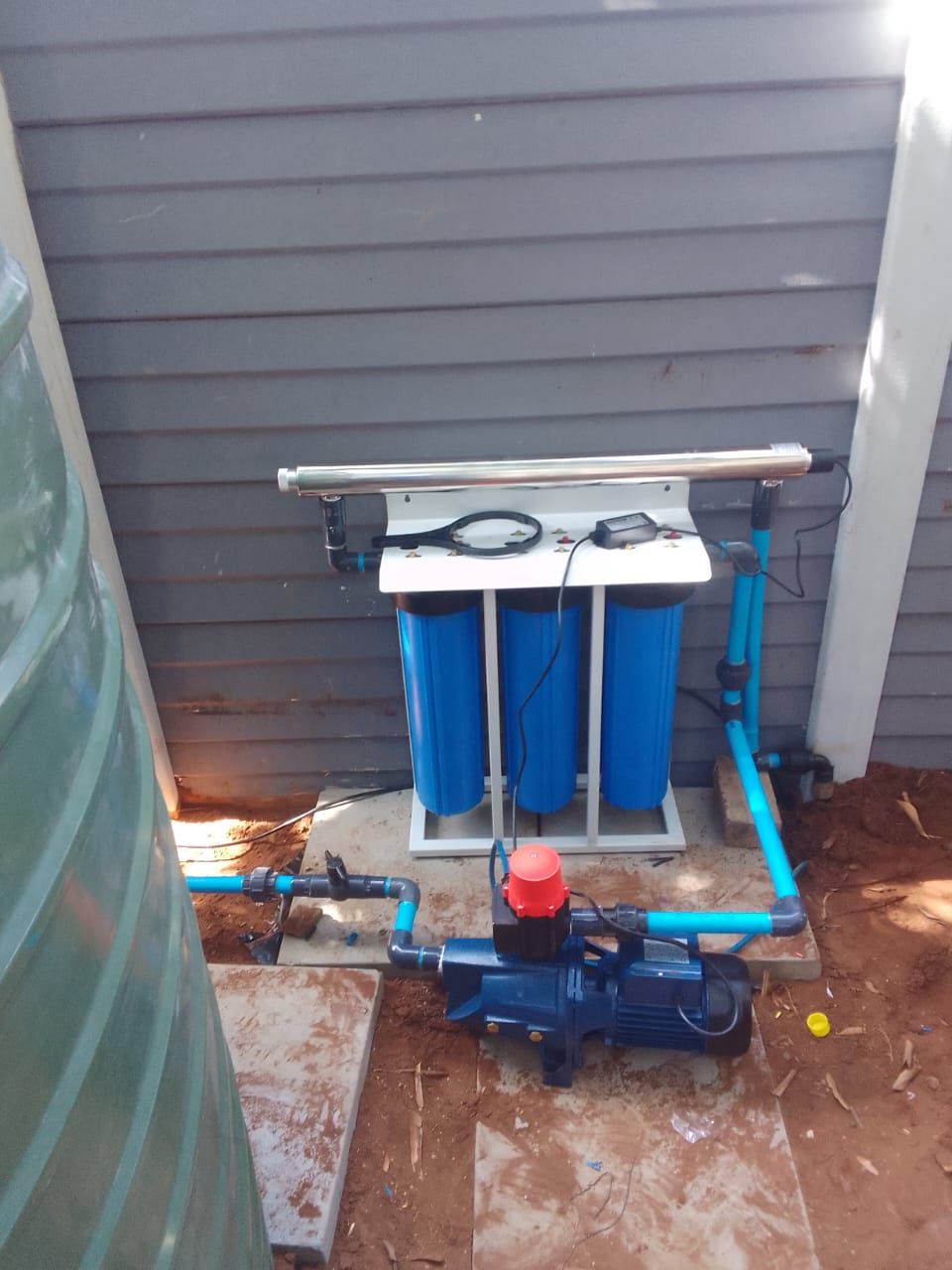 Technician inspecting water filtration system valves